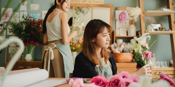 A florist arranging a wedding bouquet in her workshop