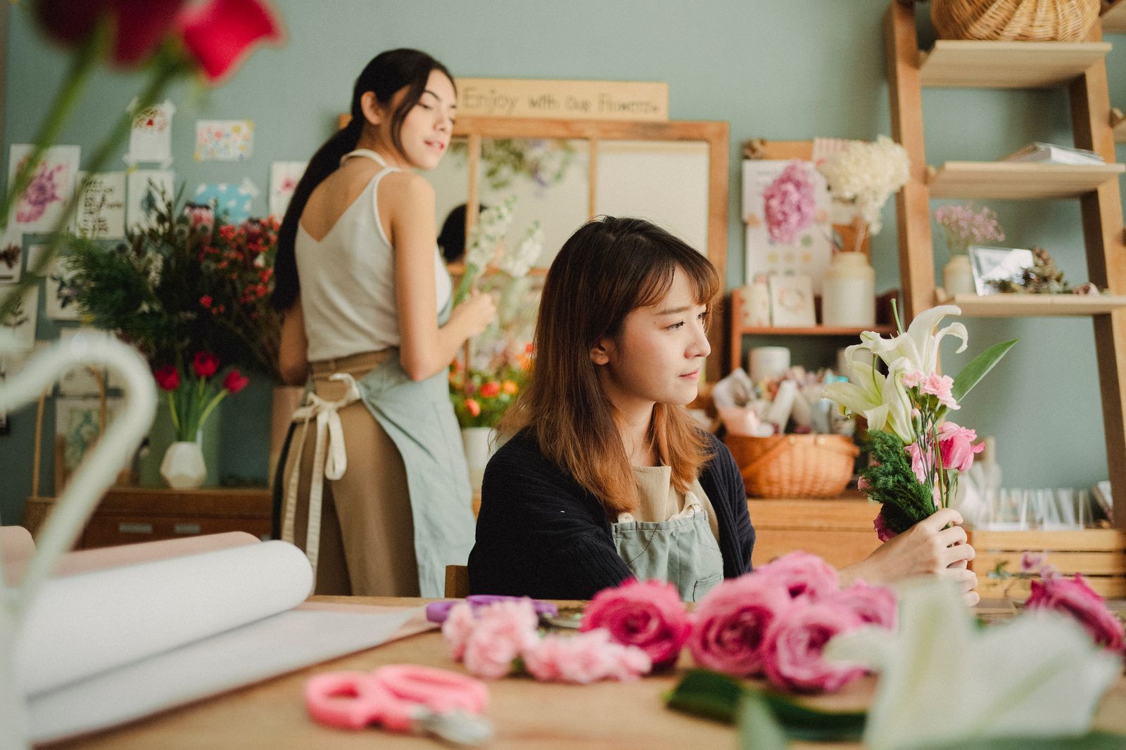A florist arranging a wedding bouquet in her workshop
